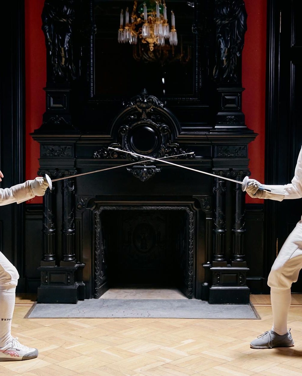 people in white long sleeves and white pants holding silver metal rod